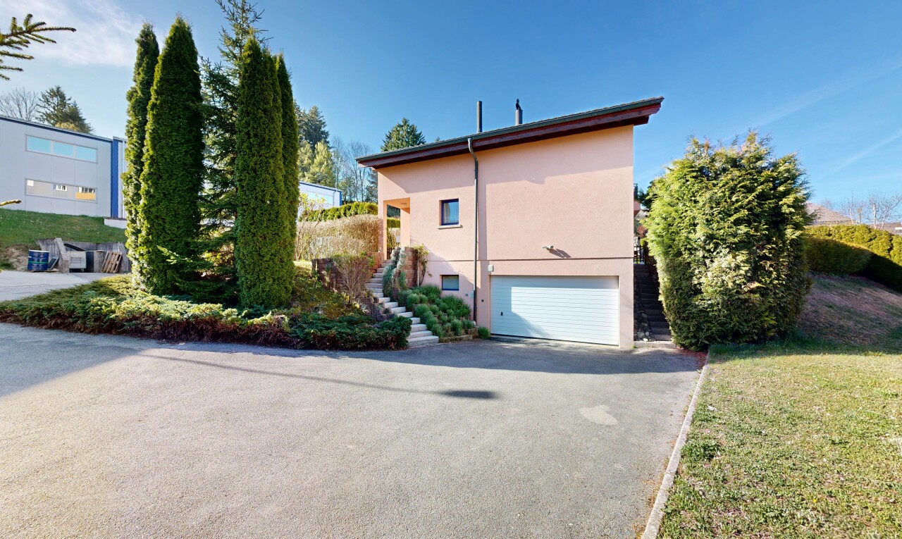 view of home featuring an attached garage, asphalt driveway, and stucco siding