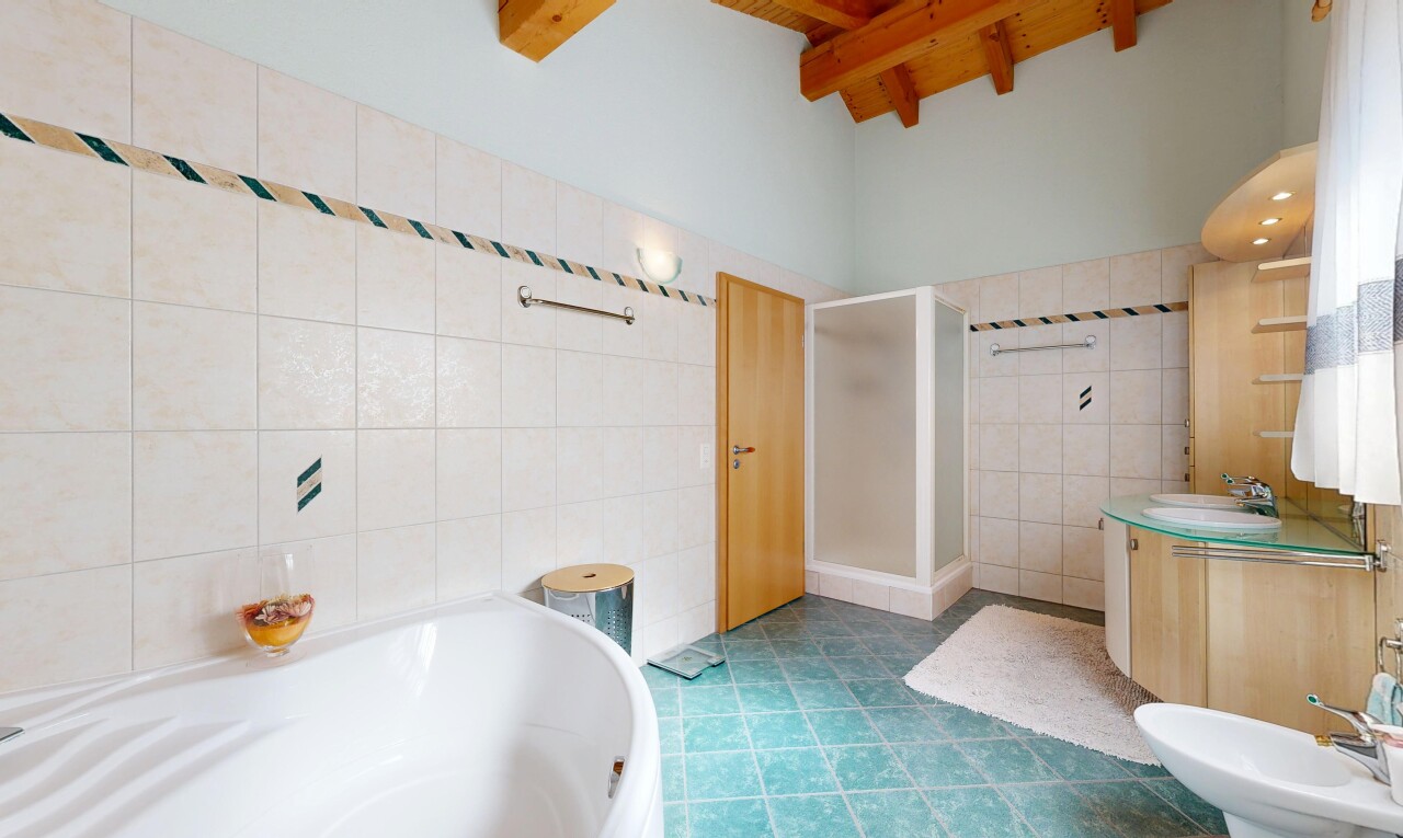 bathroom featuring a shower stall, vanity, a bidet, tile walls, and a garden tub