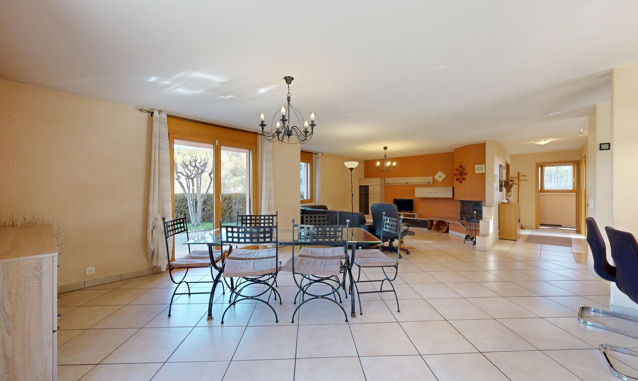 living / dining area featuring hanging lights, plenty of natural light, and light tile patterned floors
