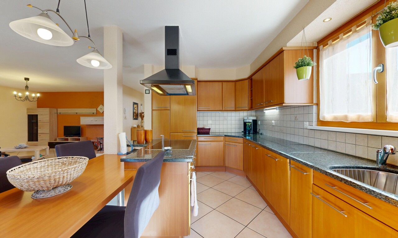 kitchen with exhaust hood, tasteful backsplash, light tile patterned flooring, wood finish cabinets, and hanging light fixtures