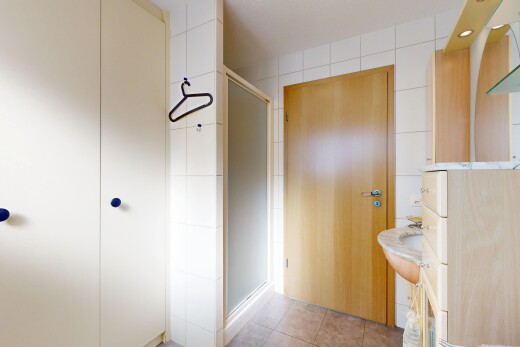 salle de bains avec light floor, douche, miroir, salle de bain complète, et tile floor