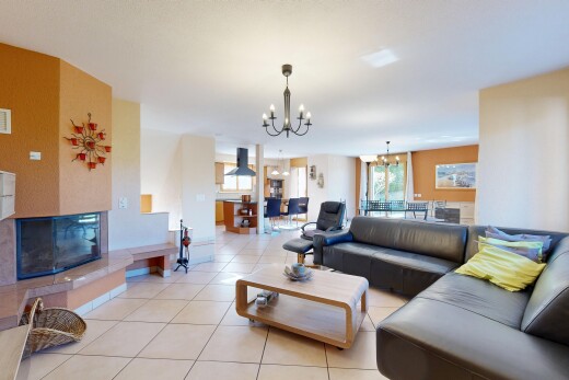 living area with hanging lights, plenty of natural light, and light tile patterned floors