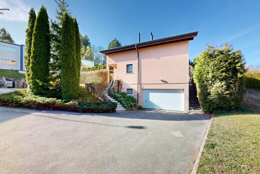 view of home featuring an attached garage, asphalt driveway, and stucco siding