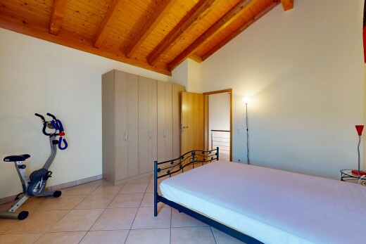 room / bedroom featuring a high wood beamed ceiling, a closet, and light tile patterned floors