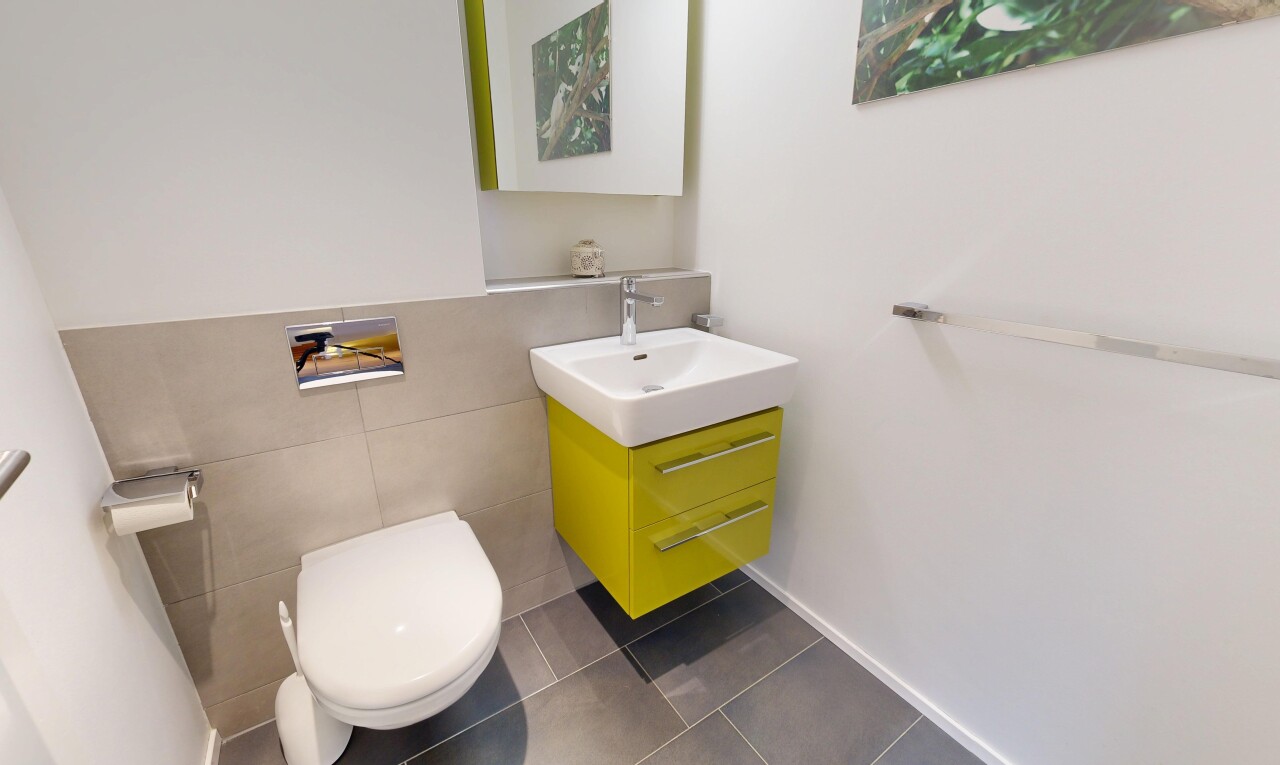 salle de bains avec tile wall, mur en carrelage, lavabo (ou coiffeuse selon le contexte), miroir, et dark floor