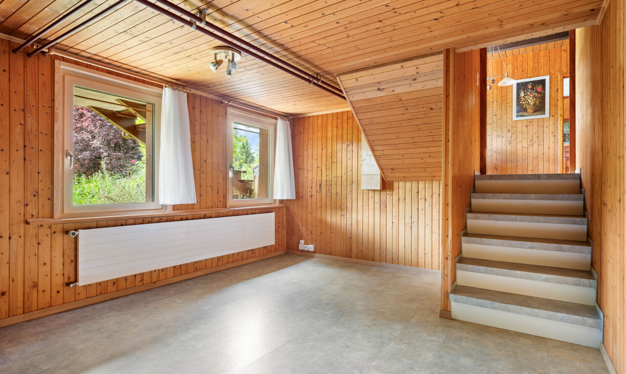stairs with wooden walls, radiator heating unit, and wood ceiling