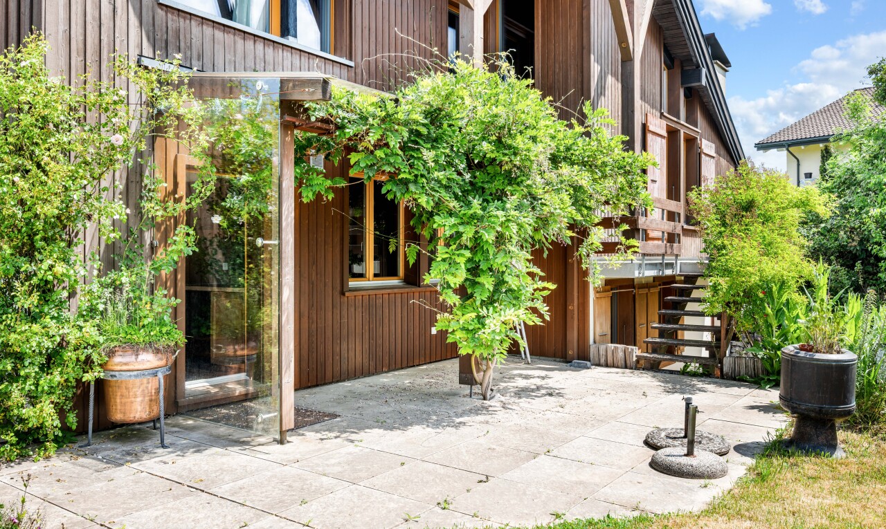 view of home featuring stairway and a patio area