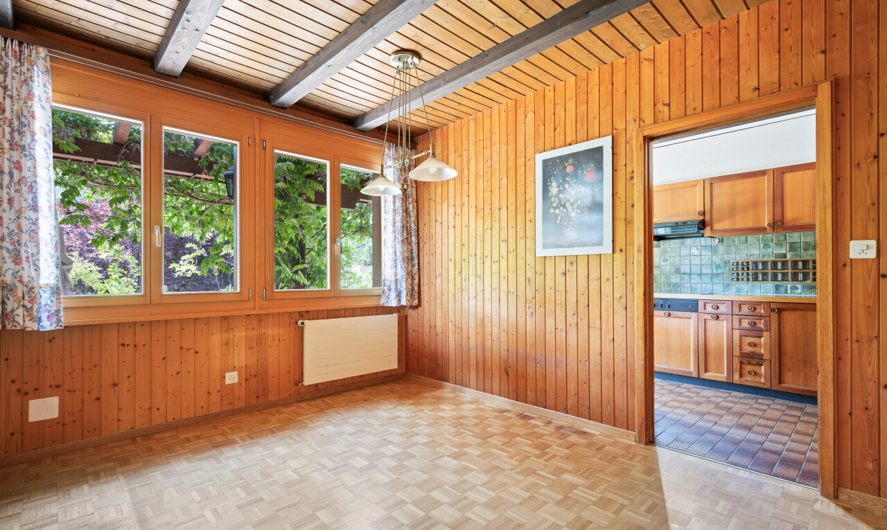 unfurnished room with wood walls, radiator heating unit, parquet flooring, and beam ceiling
