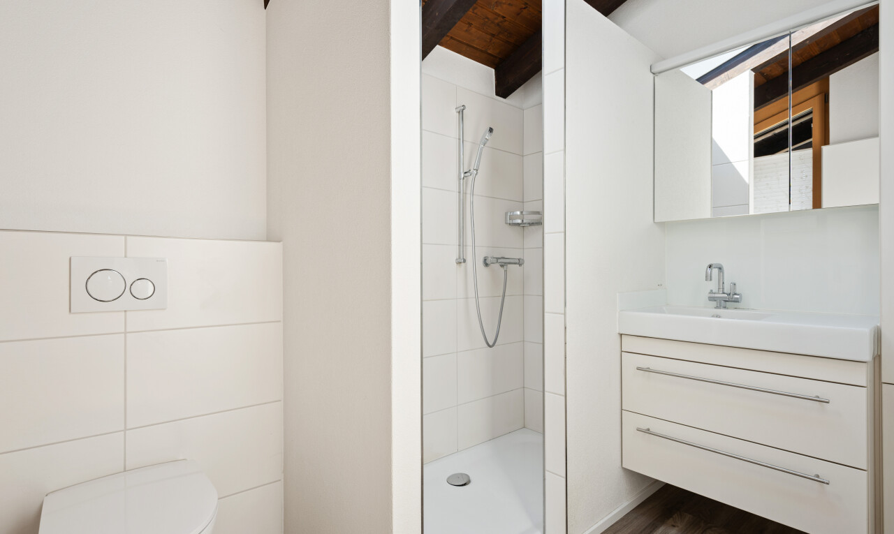 full bathroom with tiled shower, vanity, and dark wood-style floors