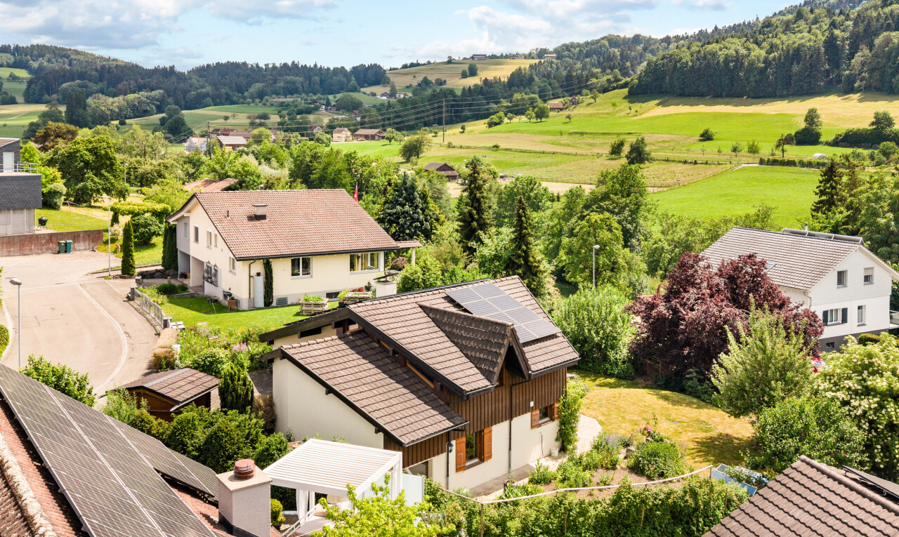 outdoor house featuring solar panels and a rural view