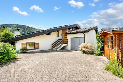 außenansicht mit stuckverkleidung, day time, garage angeschlossen, schornstein, und property visible