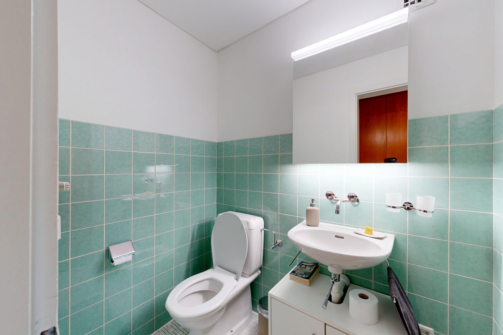 bathroom with tile walls and a wainscoted wall
