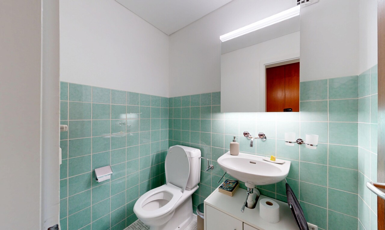 bathroom with tile walls and a wainscoted wall