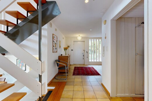 corridor featuring access to outside and light tile patterned floors