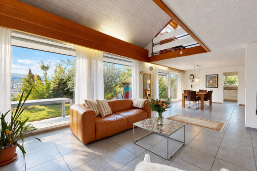 tiled living area featuring lofted ceiling and access to exterior