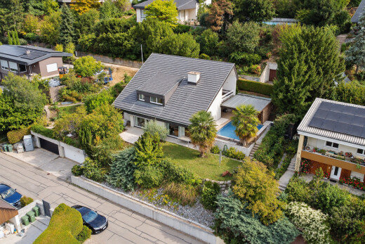 view of home with curbs