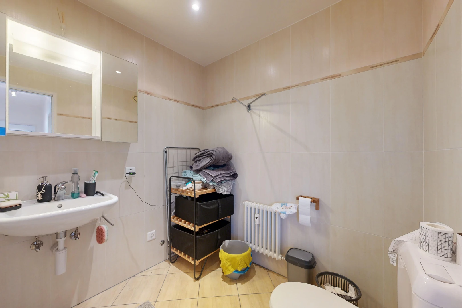 bathroom with radiator, light tile patterned floors, and recessed lighting