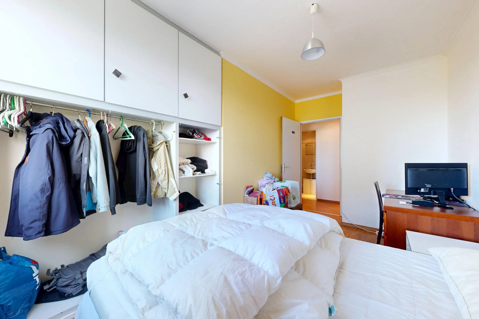 room with a closet and ornamental molding