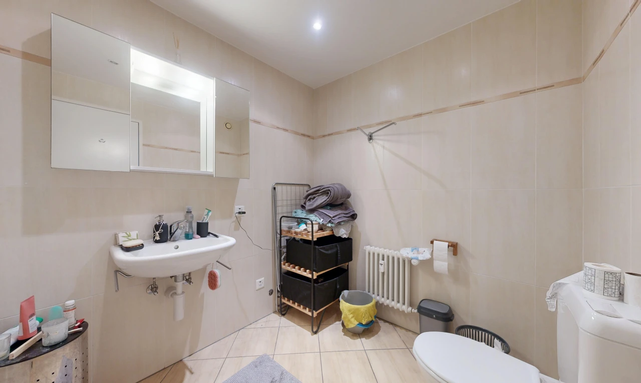 bathroom with radiator, light tile patterned floors, and recessed lighting