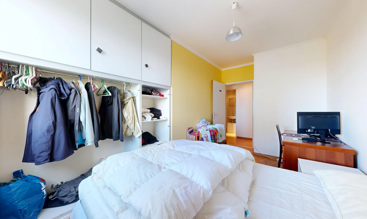 room with a closet and ornamental molding