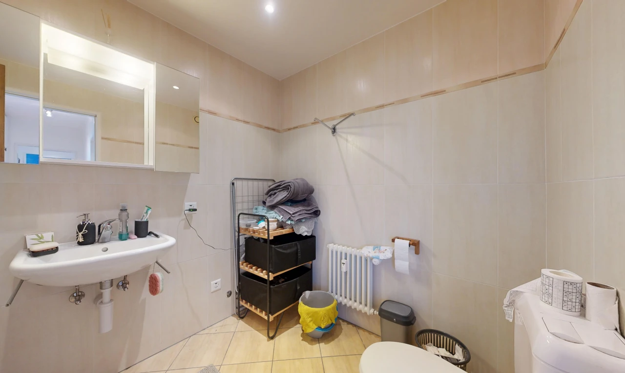 bathroom with radiator, light tile patterned floors, and recessed lighting