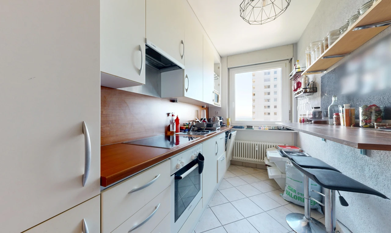 kitchen with freestanding refrigerator, oven, white cabinets, light tile patterned floors, and radiator heating unit