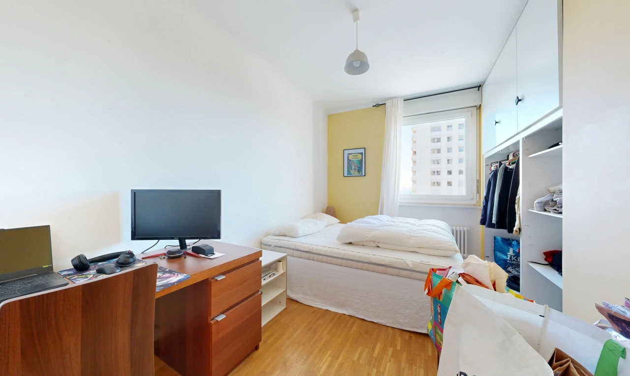 room / bedroom with light wood-type flooring, radiator, and pendant lighting