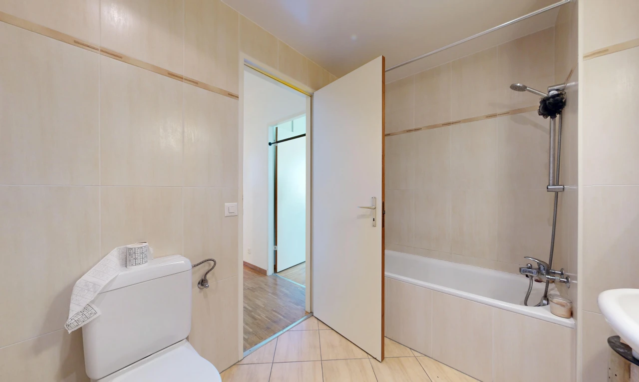 bathroom with tiled shower / bath, tile walls, and light tile patterned floors