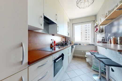 kitchen with freestanding refrigerator, oven, white cabinets, light tile patterned floors, and radiator heating unit