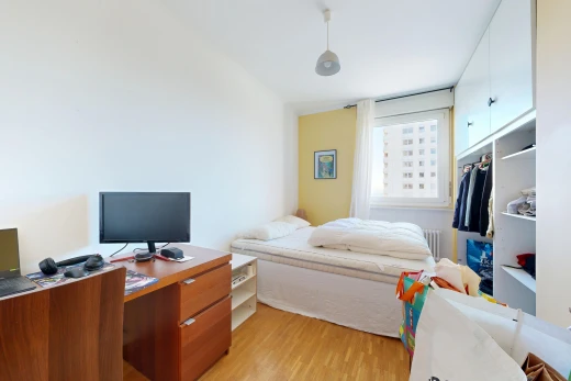 room / bedroom with light wood-type flooring, radiator, and pendant lighting