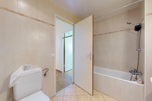 bathroom with tiled shower / bath, tile walls, and light tile patterned floors