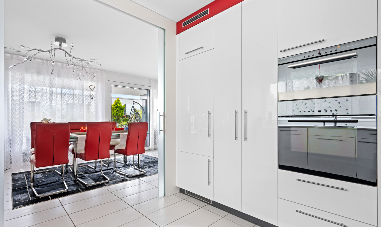 kitchen featuring stainless steel double oven, light tile patterned flooring, modern cabinets, and white cabinetry