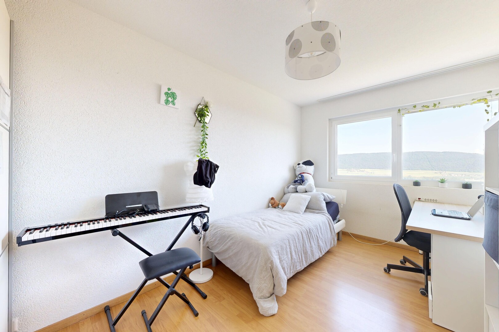 room with an office area and light wood-style floors