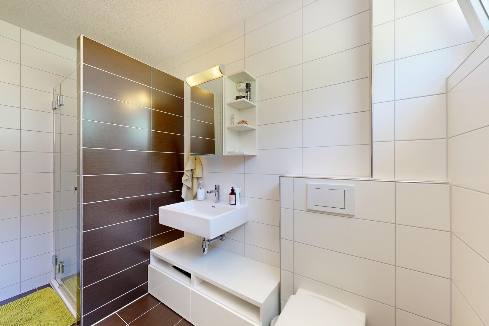 bathroom featuring tile walls and a shower stall