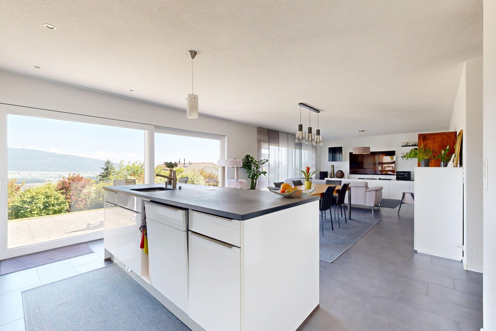 kitchen with white cabinets, a center island, dark countertops, modern cabinets, and open floor plan