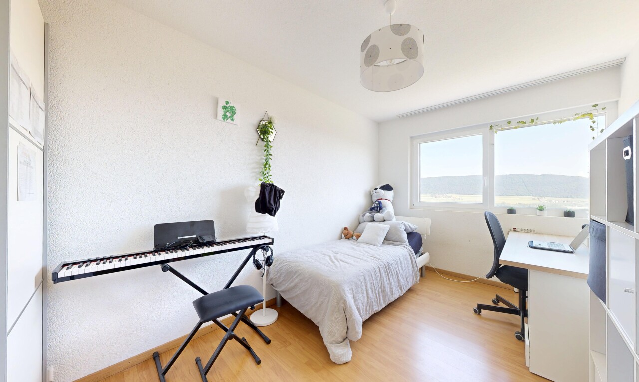 room with an office area and light wood-style floors