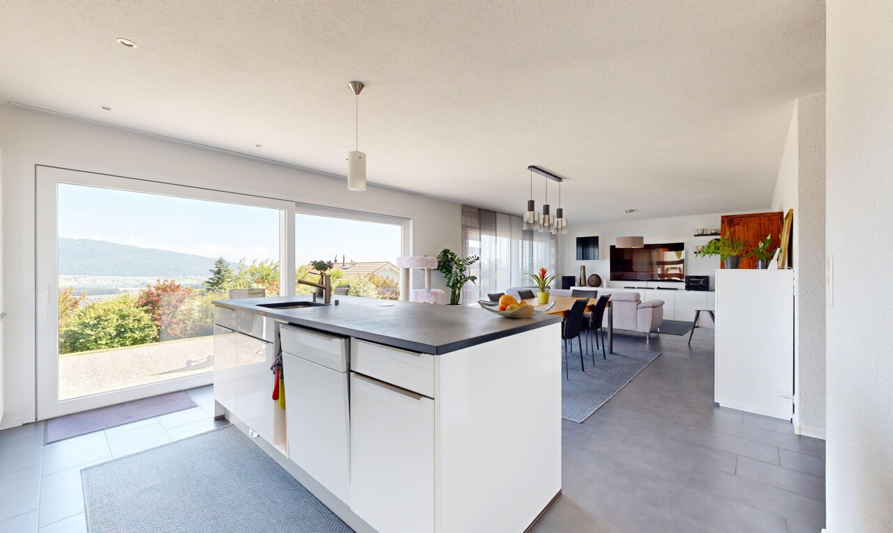 kitchen with white cabinets, a center island, dark countertops, modern cabinets, and open floor plan