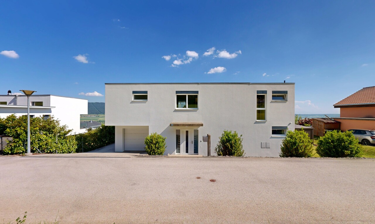 outdoor house with a garage and stucco siding