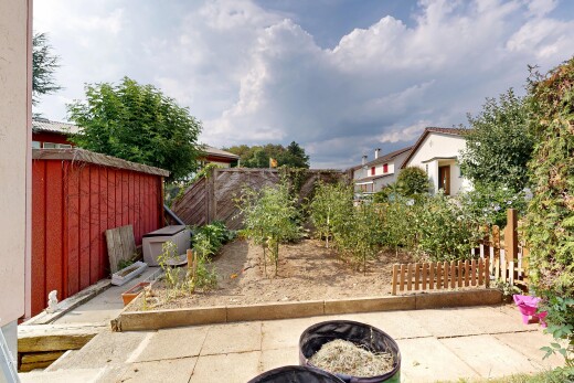 garden with a fenced backyard and a fire pit