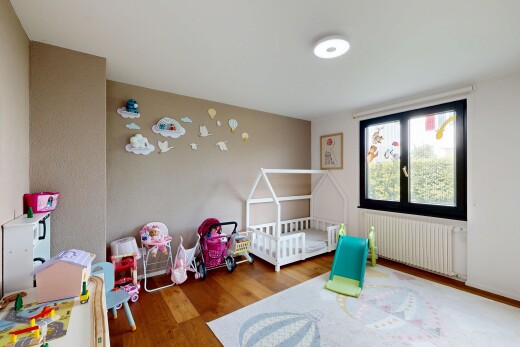 room / bedroom featuring radiator, wood finished floors, and a crib