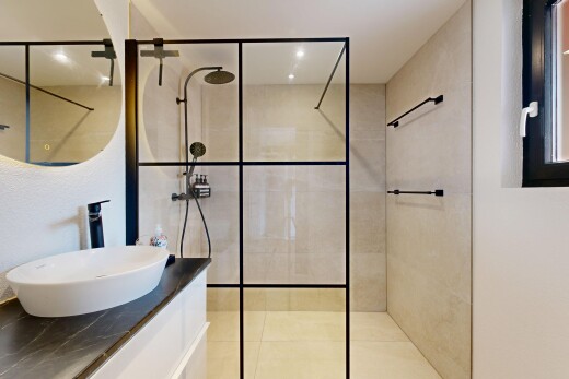 bathroom with a walk in shower and vanity