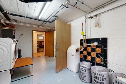 laundry area featuring finished concrete flooring and washer / clothes dryer