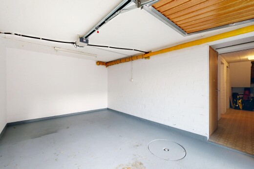 unfurnished room featuring a garage and concrete flooring