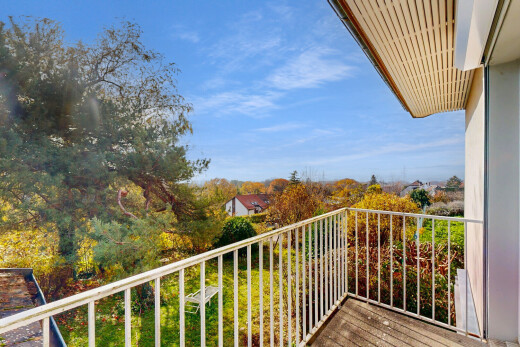 balcony featuring view of scattered trees