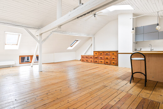 empty room with a skylight, light wood-style flooring, wood ceiling, and ceiling fan
