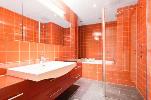 bathroom featuring tile walls, dark tile patterned floors, vanity, a stall shower, and decorative backsplash