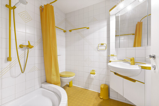 full bath with tile walls, vanity, and tiled shower / bath