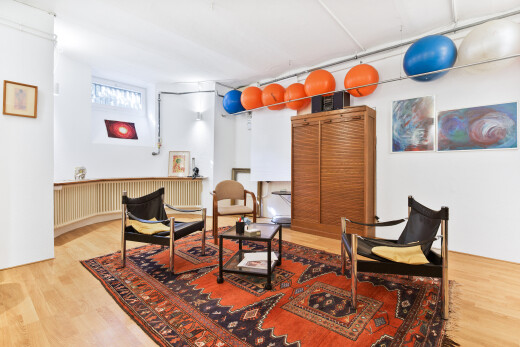 dining space with light wood finished floors and radiator heating unit