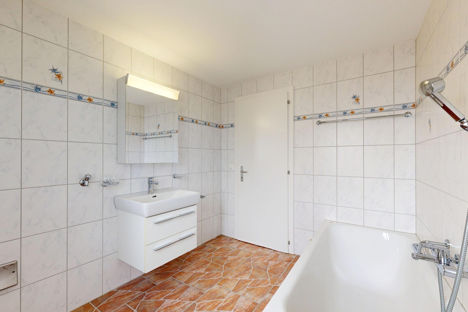 full bathroom with a garden tub, vanity, and tile walls