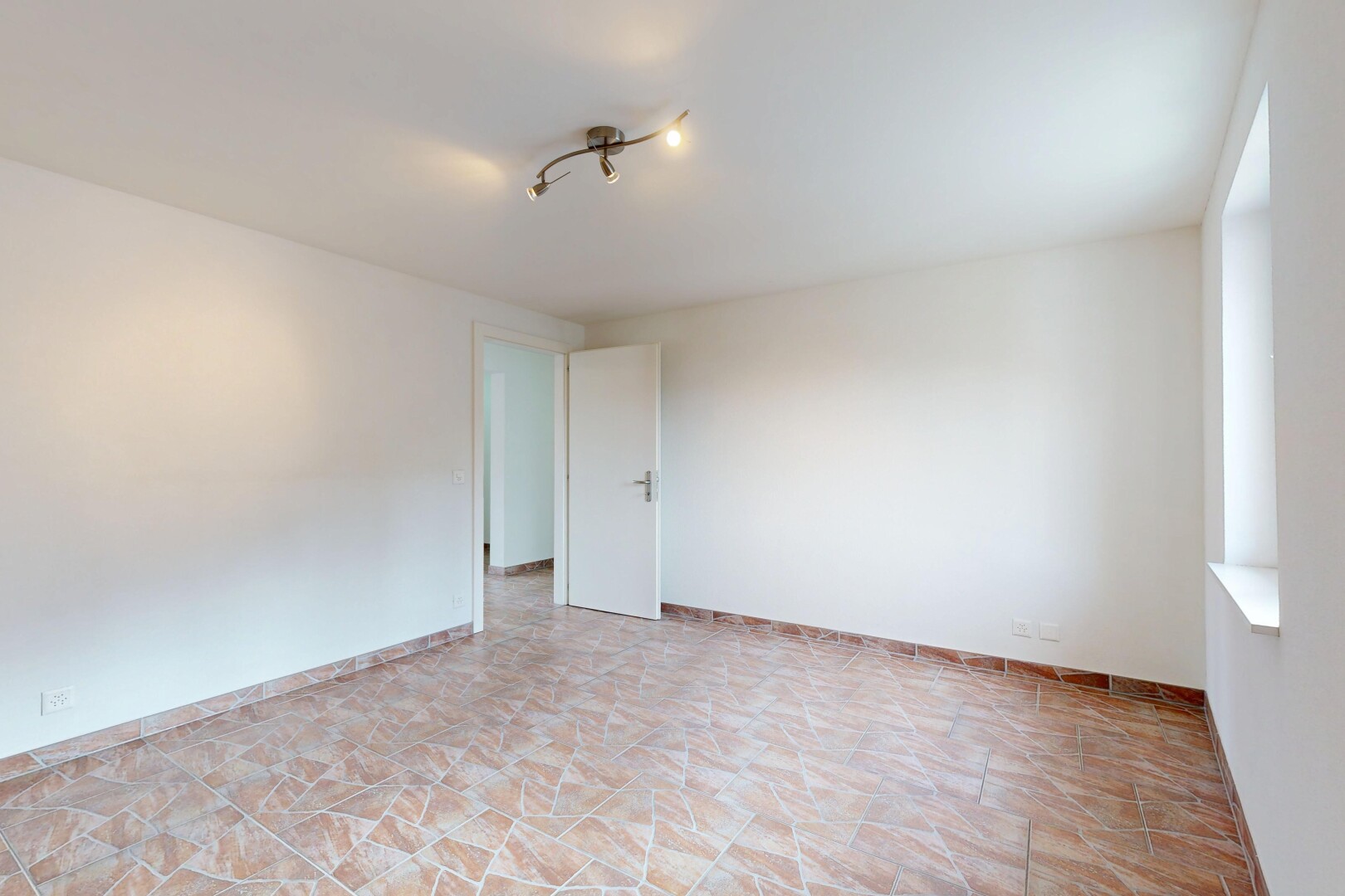 unfurnished room featuring baseboards